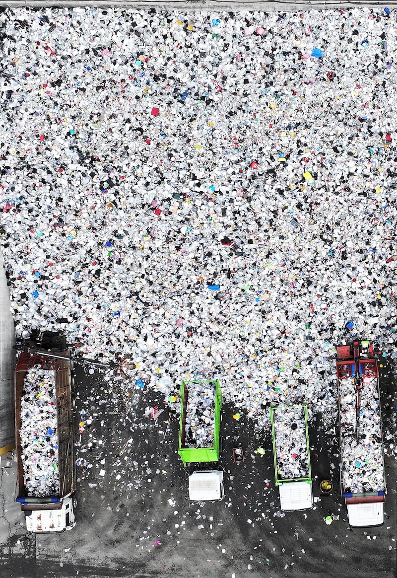 Work is under way to move piles of plastic waste at a plant that stores recyclable materials in Suwon, South Korea. EPA