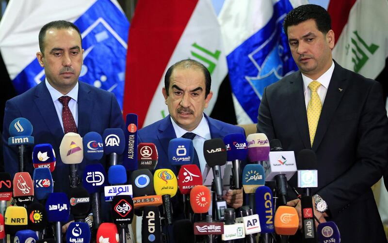 epa06748419 Riyadh Al-Badran (C), the head of Iraq's Independent Higher Election Commission, attends a press conference with members of the Commission to announce the official results of parliamentary election in Baghdad, Iraq, 19 May 2018. Iraqi electoral commission said, that the Sa'airon coalition of Iraqi Shiite cleric and head of Sadr movement Muqtada al-Sadr, has won the first place in the voting and got 54 seats in Iraq's parliamentary elections.  EPA/ALI ABBAS