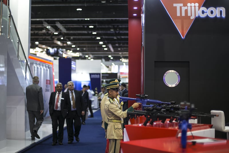 Military officer check out the sights at the stand of Trijicon, which makes optics and aiming systems for firearms, at Idex. Mona Al Marzooqi / The National