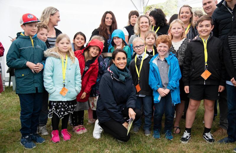 Meghan poses for pictures with New Zealanders who had turned up at the Abel Tasman National Park. AP