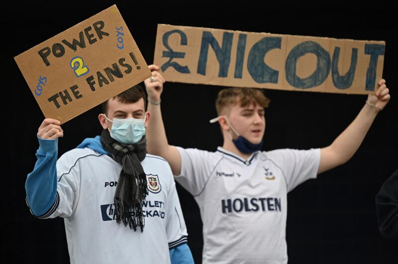 Fans hold signs saying 'Enic out'. AFP