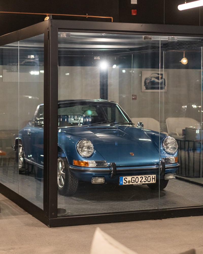 A vintage Porsche behind a glass display at DRVN.