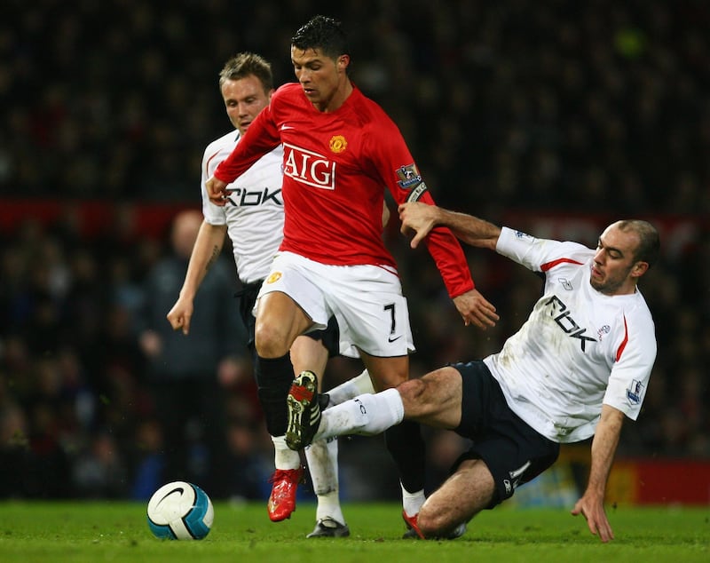 MANCHESTER, UNITED KINGDOM - MARCH 19:  Cristiano Ronaldo of Manchester United takes on Matt Taylor (L) and Gavin McCann of Bolton Wanderers during the Barclays Premier League match between Manchester United and Bolton Wanderers at Old Trafford on March 19, 2008 in Manchester, England.  (Photo by Alex Livesey/Getty Images)