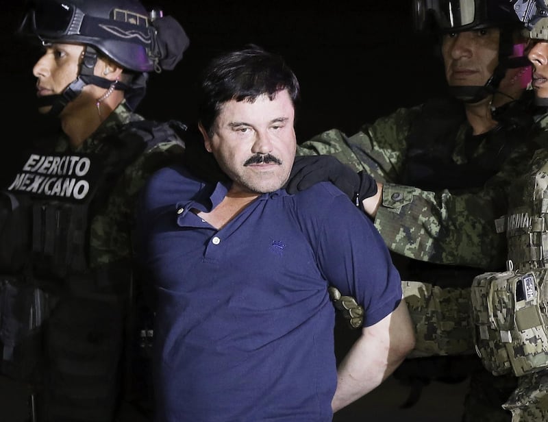 El Chapo is escorted by authorities after his detention in Mexico City in May 2016. EPA