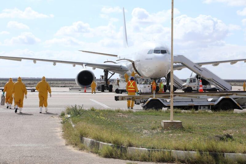 Medical team walk towards the aircraft to receive passengers that were evacuated from Wuhan, at Borg El Arab airport in Alexandria, Egypt. Reuters