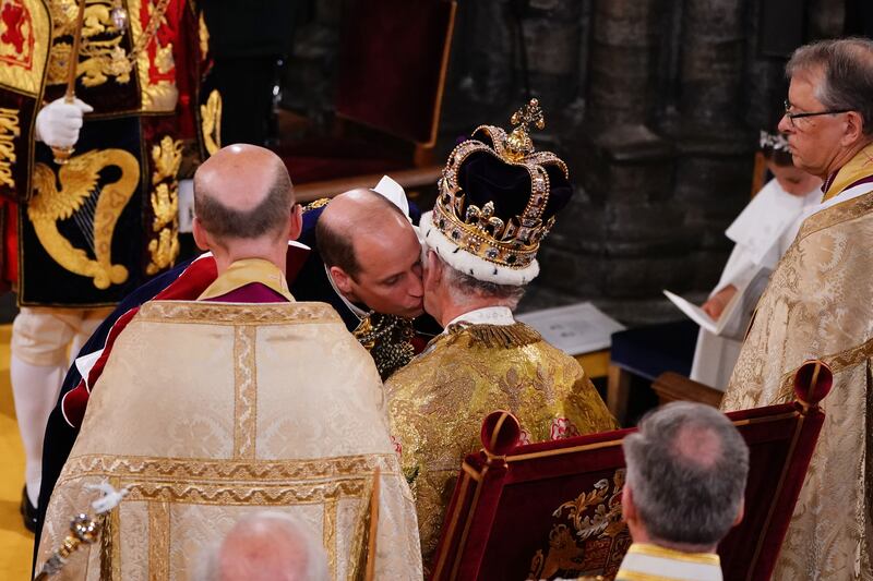 Prince William kisses his father King Charles III during his coronation ceremony. PA