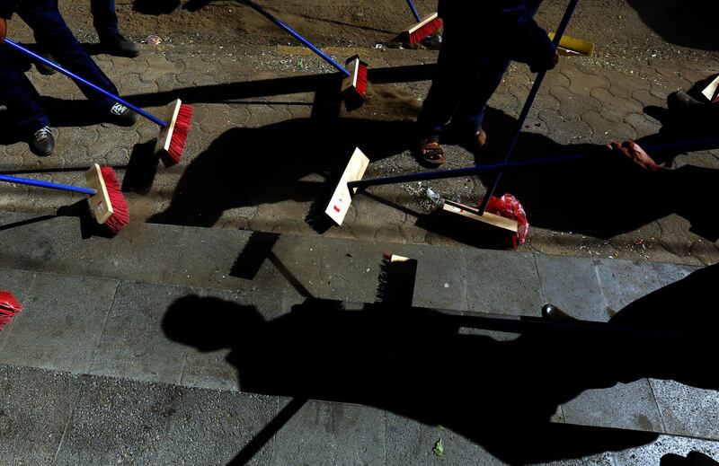 Yemenis clean up a street during a local cleanup campaign in Sana'a. EPA