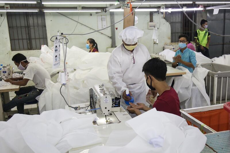 Workers sew disposable surgical gowns for health workers at a garment factory in Yangon. The factory produces 1,000 medical gowns per day to address the shortage of protective personal equipment as Myanmar battles the coronavirus pandemic. AFP