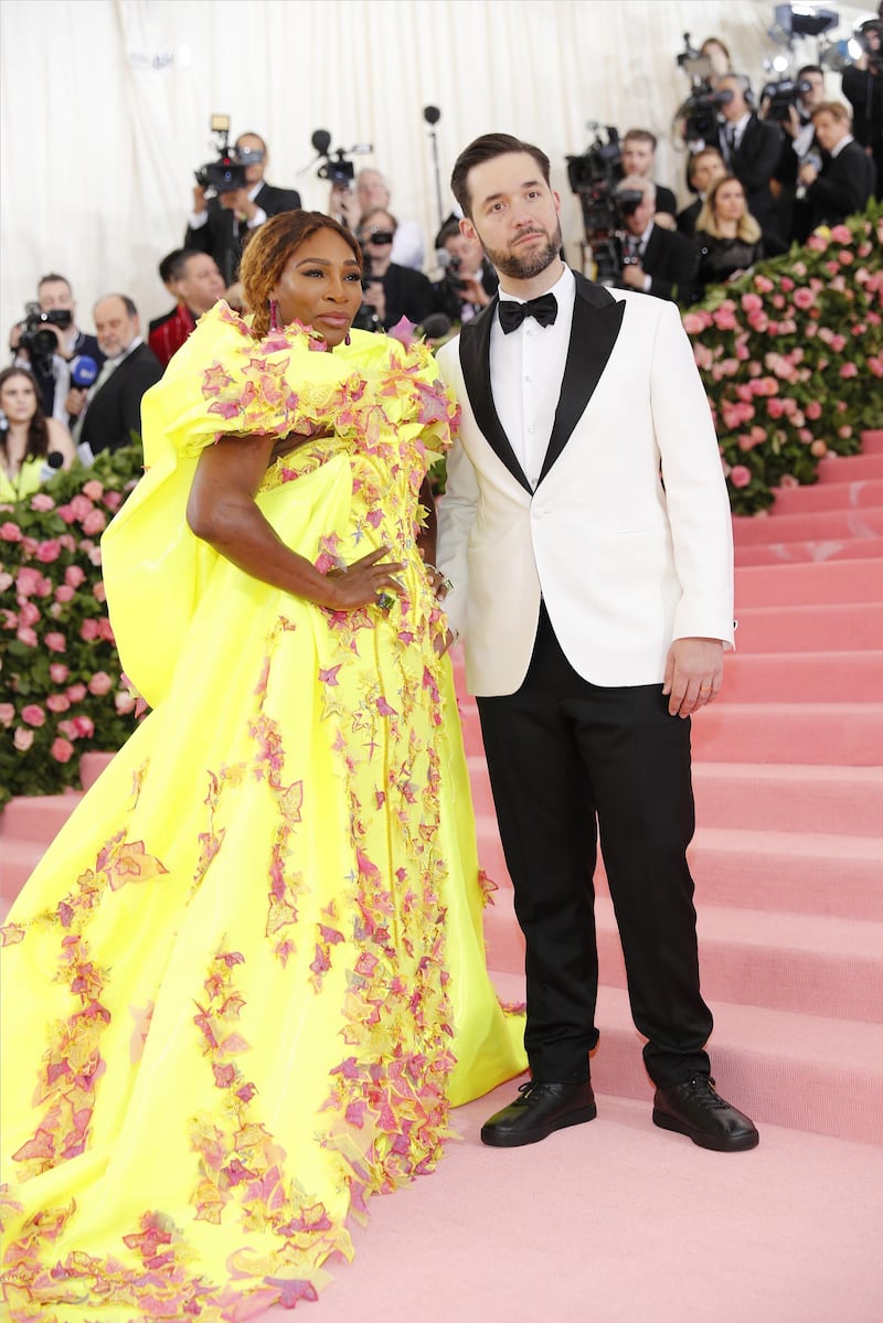 epa07552075 Serena Williams (L) and Alexis Ohanian (R) arrive on the red carpet for the 2019 Met Gala, the annual benefit for the Metropolitan Museum of Art's Costume Institute, in New York, New York, USA, 06 May 2019. Yellow dress with flowers by Versace. The event coincides with the Met Costume Institute's new spring 2019 exhibition, 'Camp: Notes on Fashion', which runs from 09 May until 08 September 2019.  EPA-EFE/JUSTIN LANE