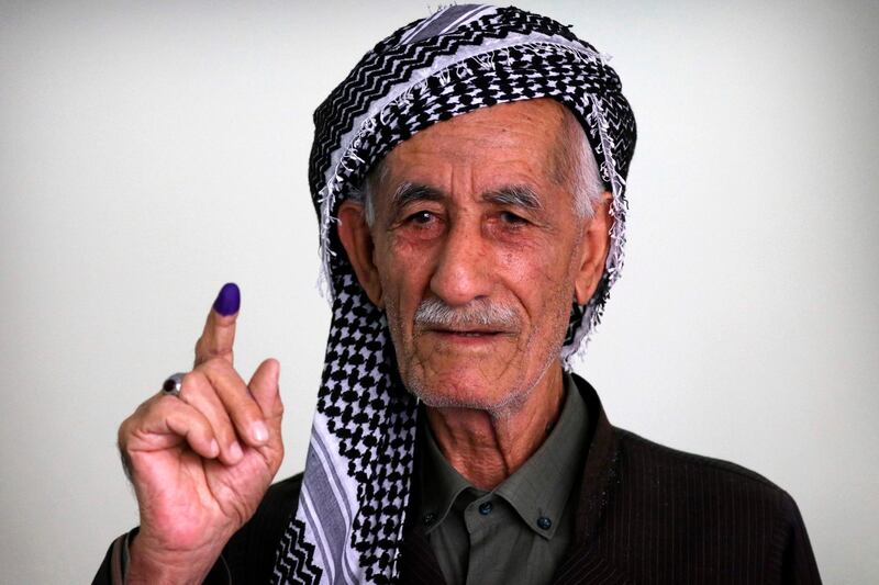 An Iraqi Kurdish man shows his ink-stained index finger after casting his ballot for the parliamentary election at a polling station in Arbil, the capital of the Kurdish autonomous region in northern Iraq. AFP