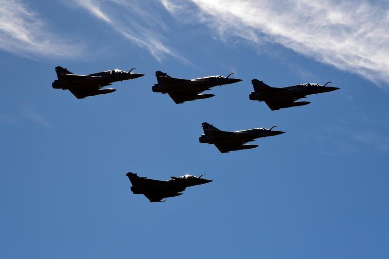 A squadron of four Hellenic Airforce fighter jets and one French Airforce perform a flyover during a joint military drill, at Tanagra military air base, about 82 kilometres (51miles) north of Athens, Greece, Thursday, Feb. 4, 2021. Greek and French military leaders observed an exercise by French Rafale fighter jets following a 2.3 billion euro deal for Greece to buy 18 of the aircraft as tensions grow with neighbor Turkey. (AP Photo/Michael Varaklas)
