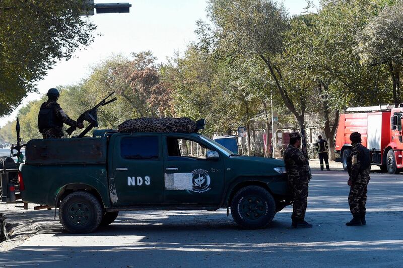 Security personnel stand guard outside of the Kabul University in Kabul. Gunmen stormed Kabul university ahead of the opening of an Iranian book fair.  AFP