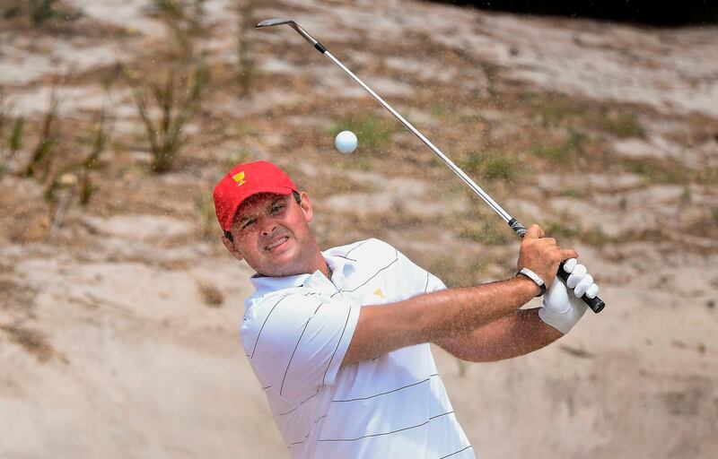 Patrick Reed of the US team hits out of a bunker. AFP