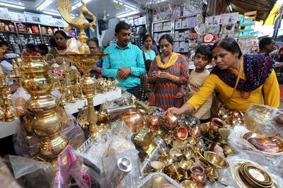 epa07949285 People buy utensils in a shop on the occasion of Dhanteras festival in Bhopal, India, 25 October 2019. Dhanteras festival is celebrated two days before the Diwali festival on which people buy utensils, gold and silver as it is considered auspicious to mark the festivity.  EPA/SANJEEV GUPTA