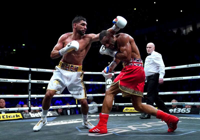 Kell Brook ducks under a left from Amir Khan. PA