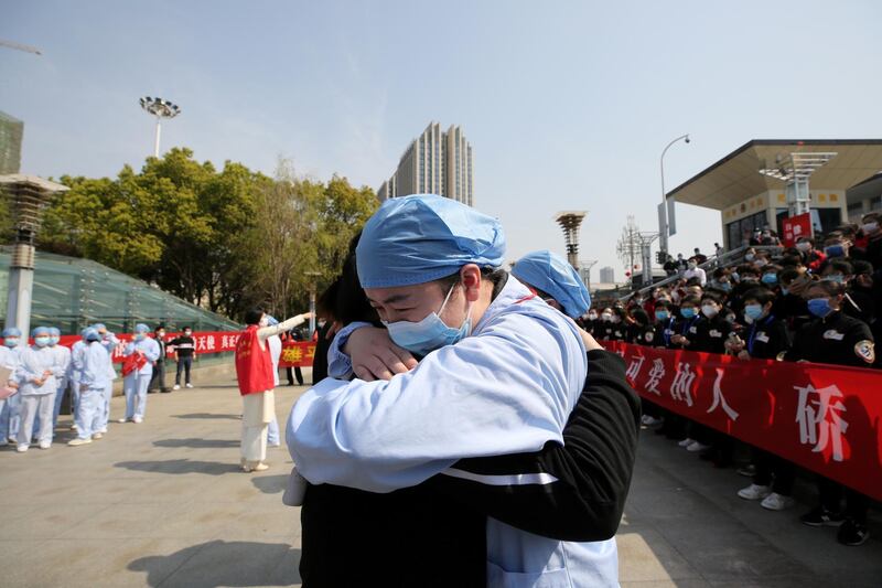 A Chinese medical worker embraces and bids farewell to a colleague at the Wuhan Railway Station. Reuters