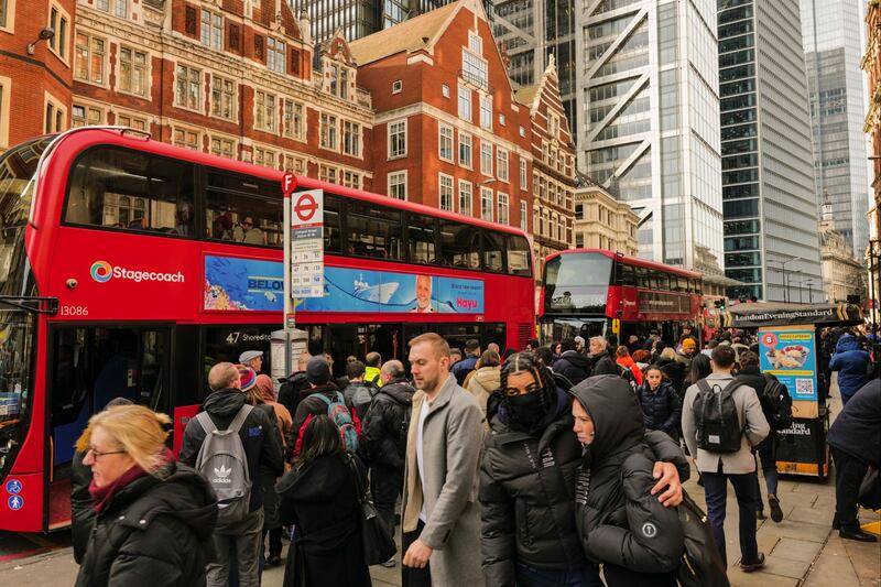 Commuters try to board buses outside Liverpool Street railway station during a strike by London Underground workers. Bloomberg