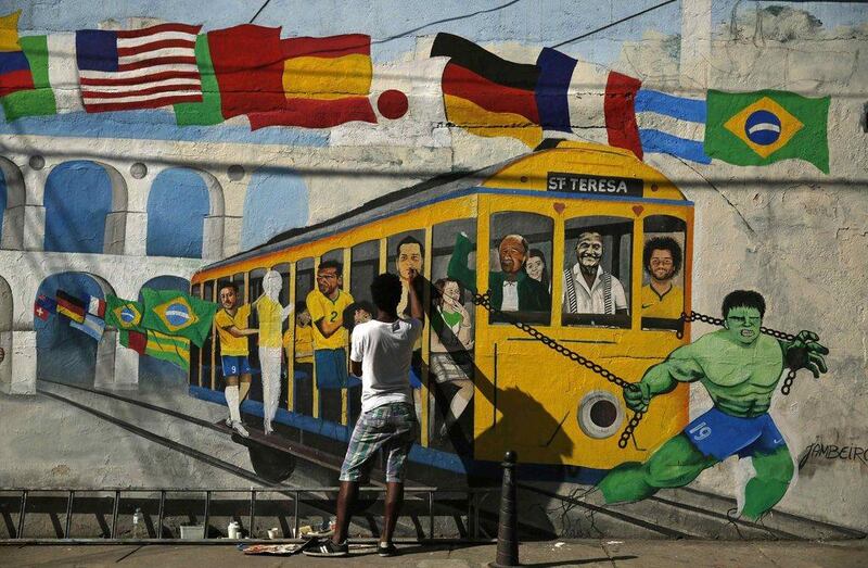 Brazilian artist Jambeiro paints a graffiti in reference to the Brazilian player Hulk and the rest of the Brazil national football team ahead of the 2014 World Cup. Pilar Olivares / Reuters / June 4, 2014