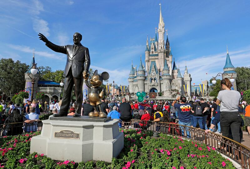 A statue of Walt Disney and Micky Mouse stands in front of Cinderella's Castle at Walt Disney World in Lake Buena Vista, Florida. AP
