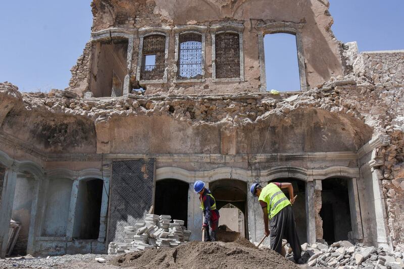 Unesco workers rebuild heritage homes in the Old City, on the west of the Tigris, in Mosul, Iraq. A UAE partnership with Unesco has provided funding of $50 million to support rebuilding historic landmarks there. Reuters