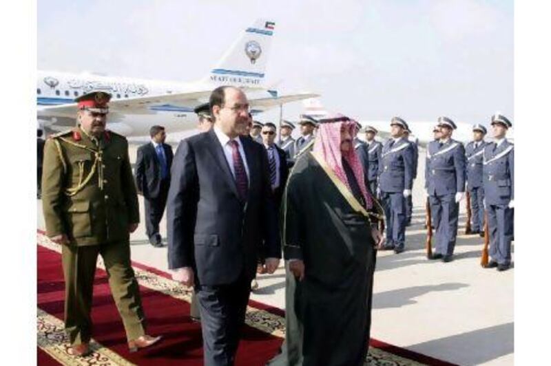 Nouri al Maliki, centre, welcomes his Kuwaiti counterpart Sheikh Nasser Mohammed al Sabah to Baghdad.