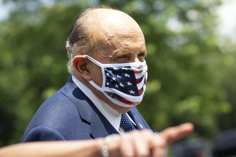 Rudy Giuliani, personal lawyer to US President Donald Trump, wears a protective mask following a television interview outside the White House in Washington DC, USA. Bloomberg
