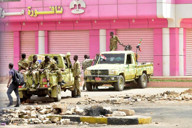 Sudanese soldiers stand guard a street in Khartoum on June 9, 2019. Sudanese police fired tear gas Sunday at protesters taking part in the first day of a civil disobedience campaign, called in the wake of a deadly crackdown on demonstrators. Protesters gathered tyres, tree trunks and rocks to build new roadblocks in Khartoum's northern Bahari district, a witness told AFP, but riot police swiftly moved in and fired tear gas at them. / AFP / -
