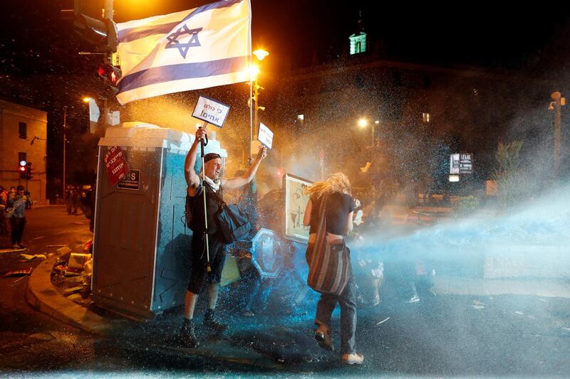 Police use water cannon during a protest against Israeli Prime Minister Benjamin Netanyahu's alleged corruption and his government's handling of the coronavirus crisis. Reuters