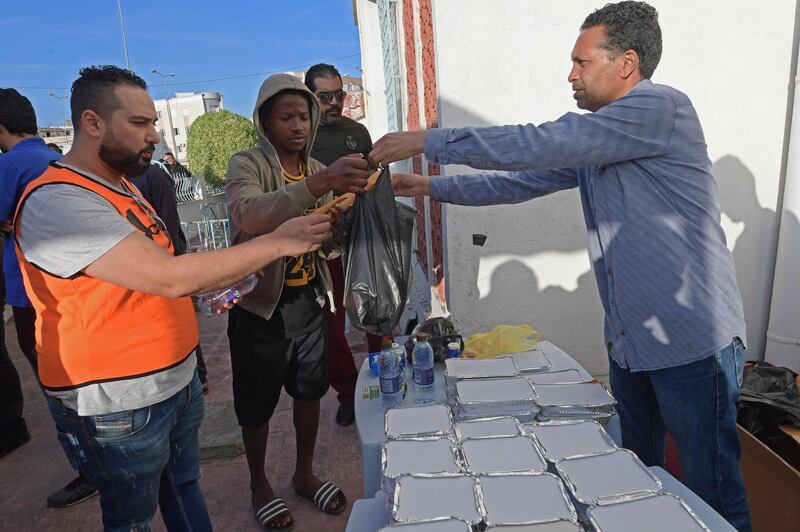 Tunisian volunteers distribute free Iftar meals at the Ariana near Tunis during Ramadan. AFP
