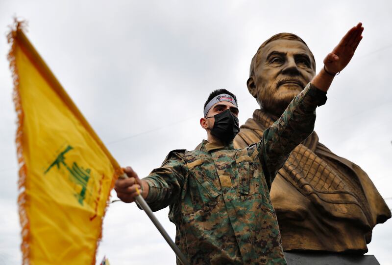 A Hezbollah fighter holds his group's flag in Beirut, Lebanon. AP
