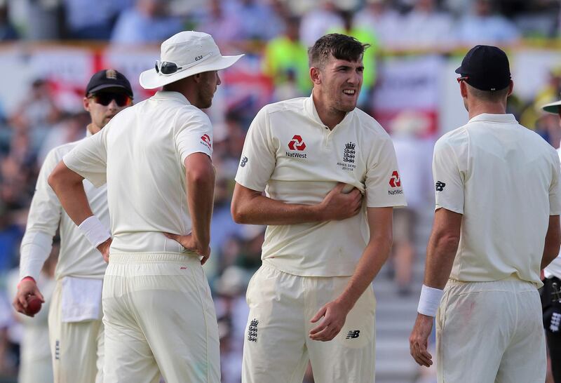 England's Craig Overton, second right, grabs at his chest after he appeared to have suffered an injury while bowling to Australia during the second day of their Ashes cricket test match in Perth, Australia, Friday, Dec. 15, 2017. (AP Photo/Trevor Collens)
