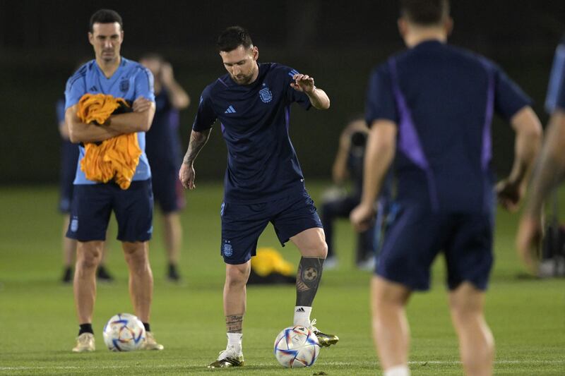 Lionel Messi on the ball next to Argentina coach Lionel Scaloni during a training session at Qatar University. AFP