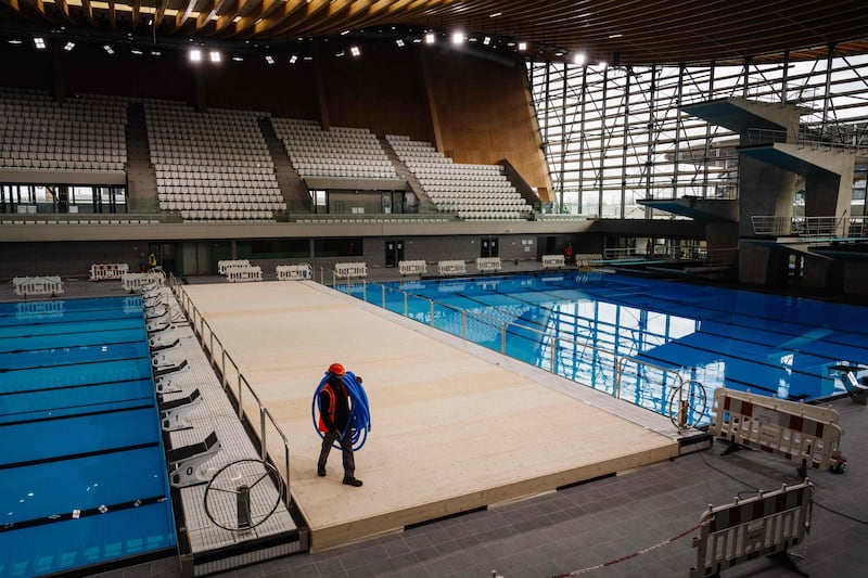 Maintenance work is carried out at the swimming pools in the Aquatics Centre, built for the Olympics in Saint Denis. AFP