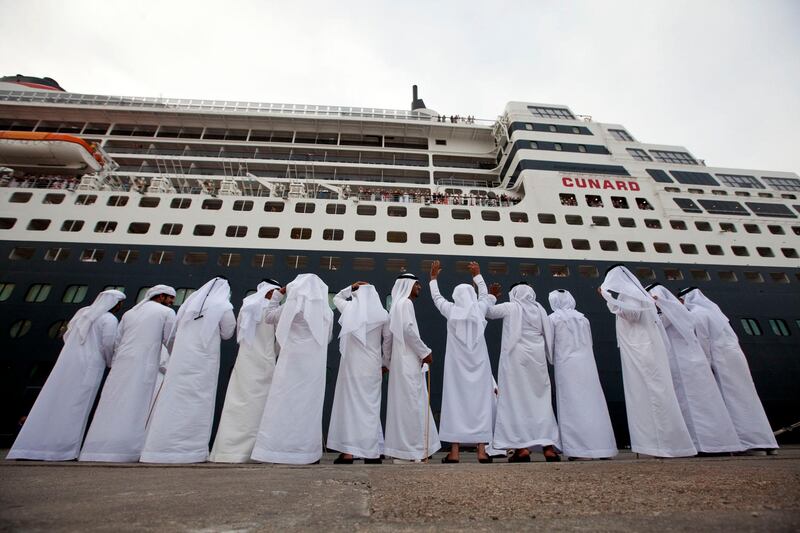 Abu Dhabi, United Arab Emirates, January 29, 2013:    Emirati dancers perform for passengers as they wait to disembark from the Queen Mary 2 ocean liner docks for the first time at Mina Zayed in Abu Dhabi on January 29, 2013. Christopher Pike / The National