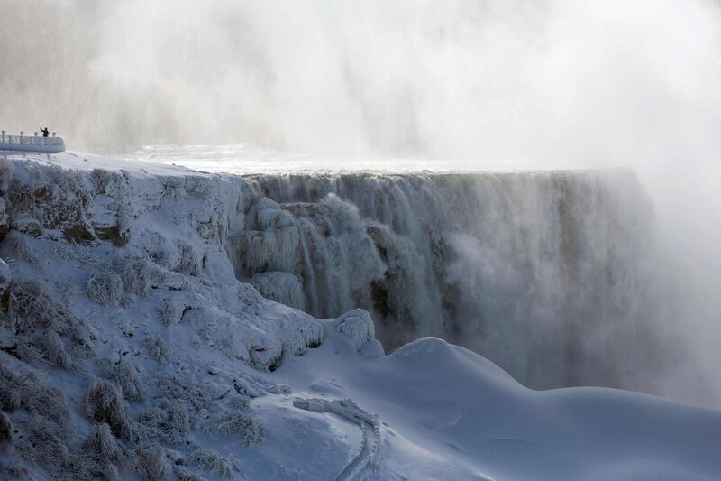 A person takes a selfie at a frozen Niagara Falls. AFP