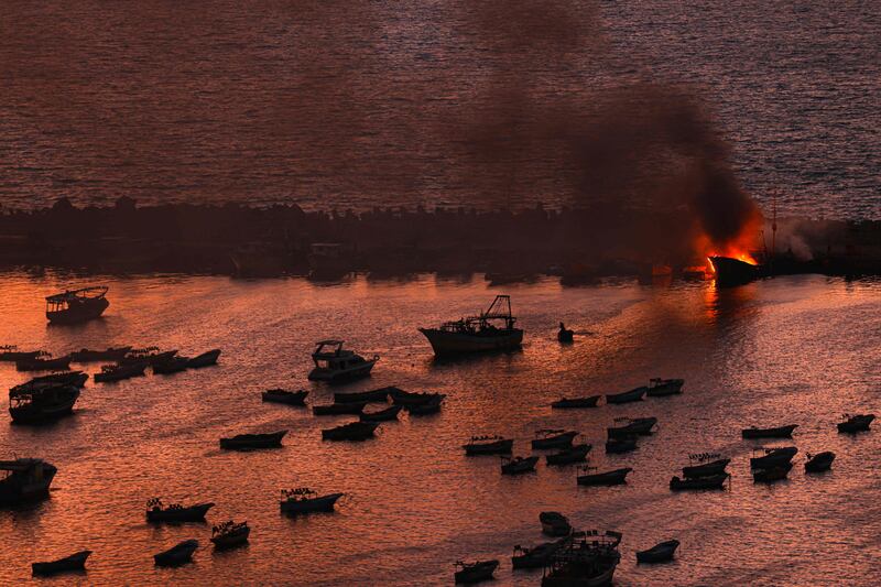 Smoke billows from a boat after a strike by Israel on the port of Gaza City. AFP