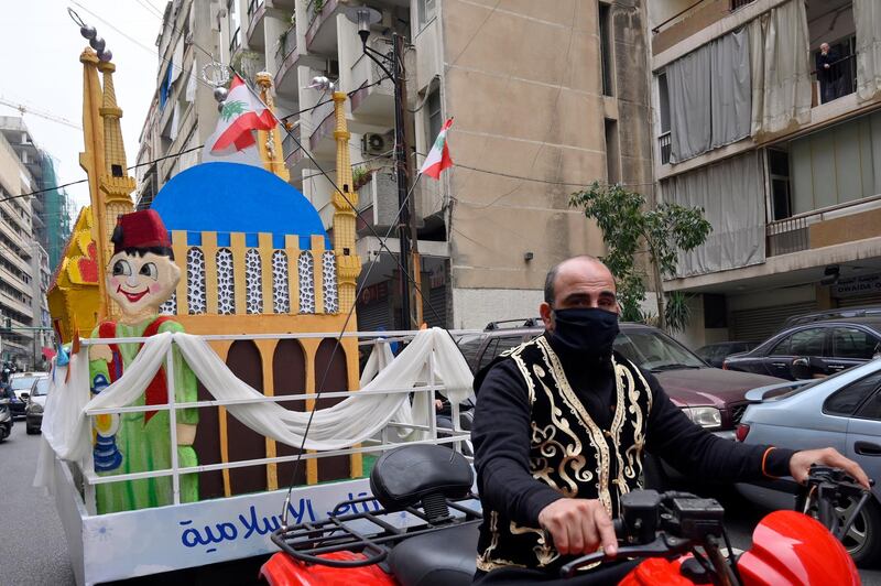 A Lebanese supporter of the Jemaah Islamiyah wears a medical mask, drives his ATV to celebrate in the first day of Ramadan in Beirut, Lebanon, 24 April 2020. EPA