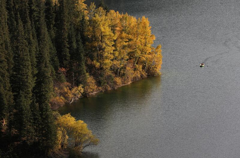 People row a boat during an autumn day at the Kolsai lake in Almaty region, Kazakhstan. Reuters
