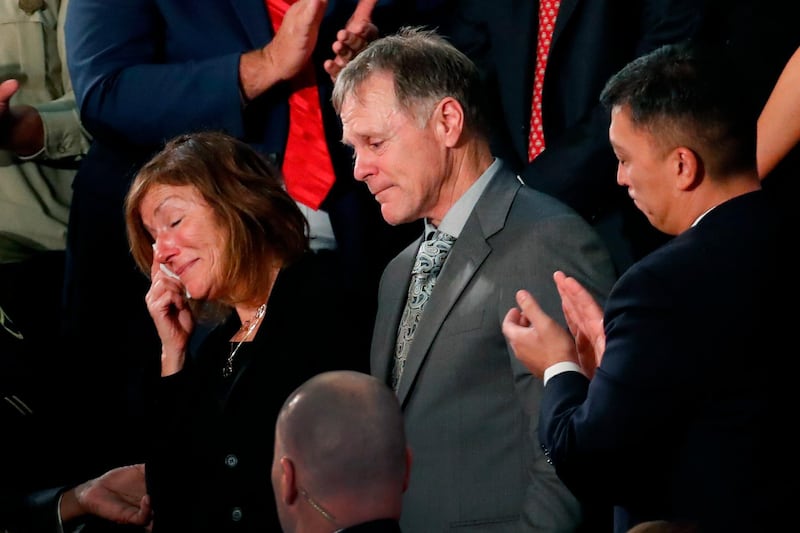 FILE - In this Jan. 30, 2018, file photo, the teary-eyed parents of Otto Warmbier, the American student who died days after being freed from imprisonment in North Korea, react to a standing ovation during President Donald Trump's State of the Union address to a joint session of Congress on Capitol Hill in Washington. The parents of U.S. college student Otto Warmbier filed a wrongful death lawsuit against North Korea on April 26, 2018, saying its government tortured and killed their son. (AP Photo/Pablo Martinez Monsivais, File)