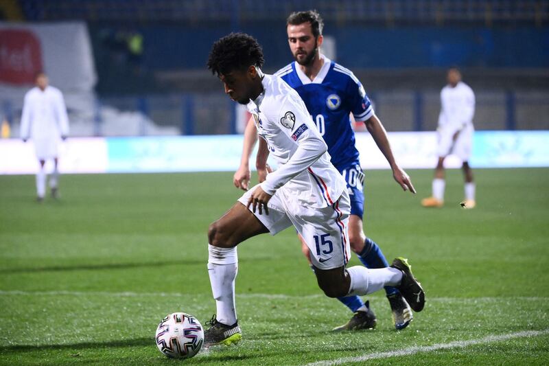 France's forward Kingsley Coman (front C) fights for the ball with Bosnia-Herzegovina's midfielder Miralem Pjanic (rear R) during the FIFA World Cup Qatar 2022 qualification Group D football match between Bosnia-Herzegovina and France at the Grbavica Stadium, in Sarajevo, on March 31, 2021. (Photo by FRANCK FIFE / AFP)