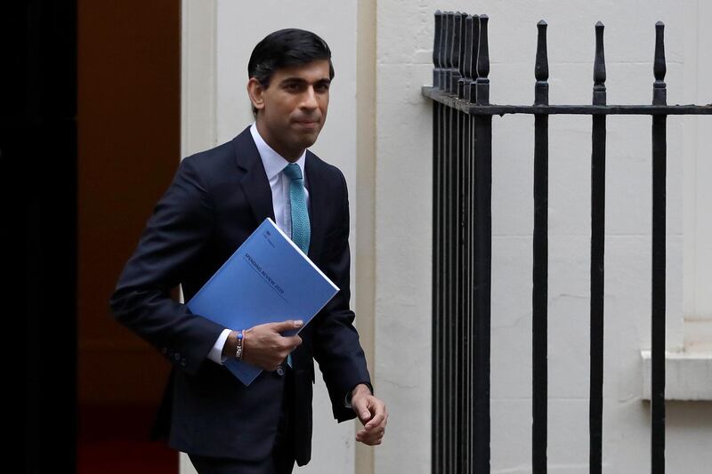FILE - In this file photo dated Wednesday, Nov. 25, 2020, Britain's Chancellor of the Exchequer Rishi Sunak leaves Downing Street in London.  Treasury chief Sunak has committed to ending the widely unpopular tax on womenâ€™s sanitary products, but the change could only take effect Friday Jan 1, 2021, after Britain had finally left the economic orbit of the EU.(AP Photo/Kirsty Wigglesworth, FILE)