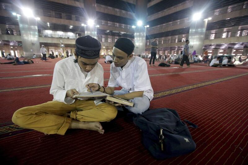 Indonesian Muslims read the Quran after praying to celebrate the holy month of Ramadan at Istiqlal Mosque in Jakarta, Indonesia. EPA
