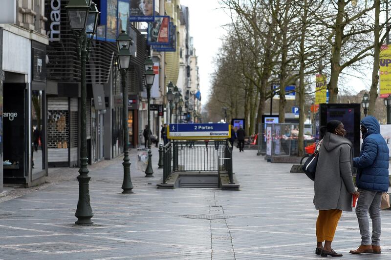 Pedestrians walk past shop in Brussels following an outbreak of coronavirus disease (COVID-19) in Brussels, Belgium, March 14 2020. REUTERS/Johanna Geron