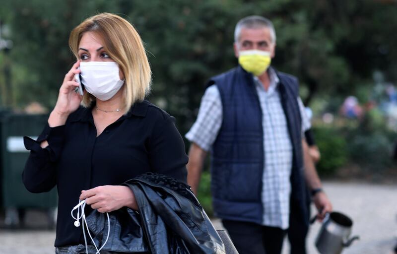 People wearing masks to help protect against the spread of coronavirus, walk in Ankara, Turkey. Turkey's health minister says the country will start to report its total number of coronavirus cases later this week after Ankara was criticized for only releasing figures for patients showing symptoms of infection. AP Photo