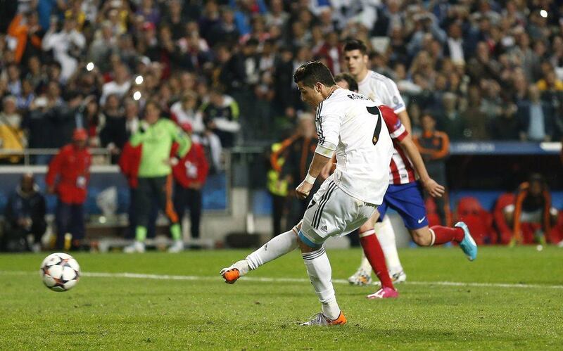 Real Madrid striker Cristiano Ronaldo takes and converts a penalty shot to put Real Madrid 4-1 up against Atletico Madrid in their Champions League final victory on Saturday. Andres Kudacki / AP / May 24, 2014