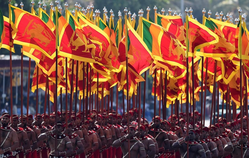 Sri Lankan military personnel march with the national flag during Sri Lanka's 70th Independence Day celebrations in Colombo. Ishara S. Kodikara / AFP Photo