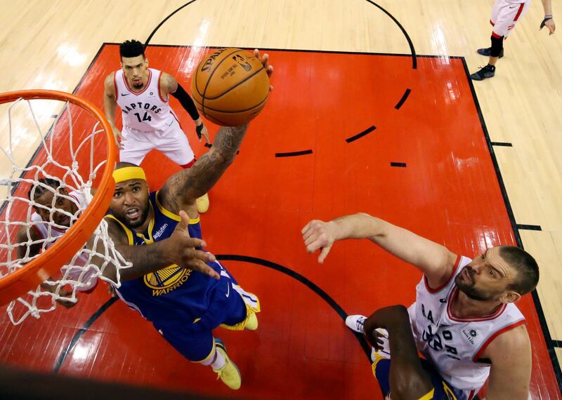 Golden State Warriors' DeMarcus Cousins (0) drives against Toronto Raptors' Marc Gasol (33), Danny Green (14) and Kawhi Leonard, left. AP Photo