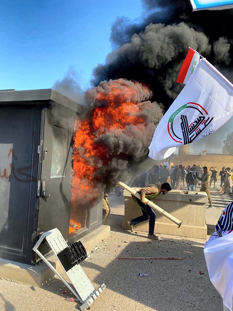 Protesters burn property in front of the US embassy compound, in Baghdad. Twitter/ @SaadoonMustafa