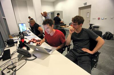 Head choreographer Peter Kopik (red shirt) in the control room above The Dubai Fountain, working on a new performance on WET’s proprietary programming software, Courtesy WET