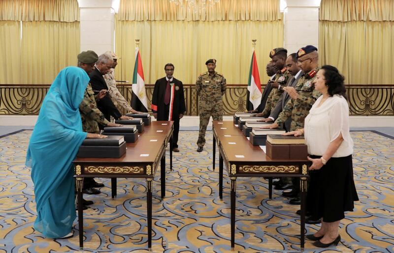 Leader of Sudan's transitional council, Lieutenant General Abdel Fattah Al-Abdelrahman Burhan looks on as military and civilian members of Sudan's new ruling body, the Sovereign Council, are sworn in at the presidential palace in Khartoum, Sudan. Reuters